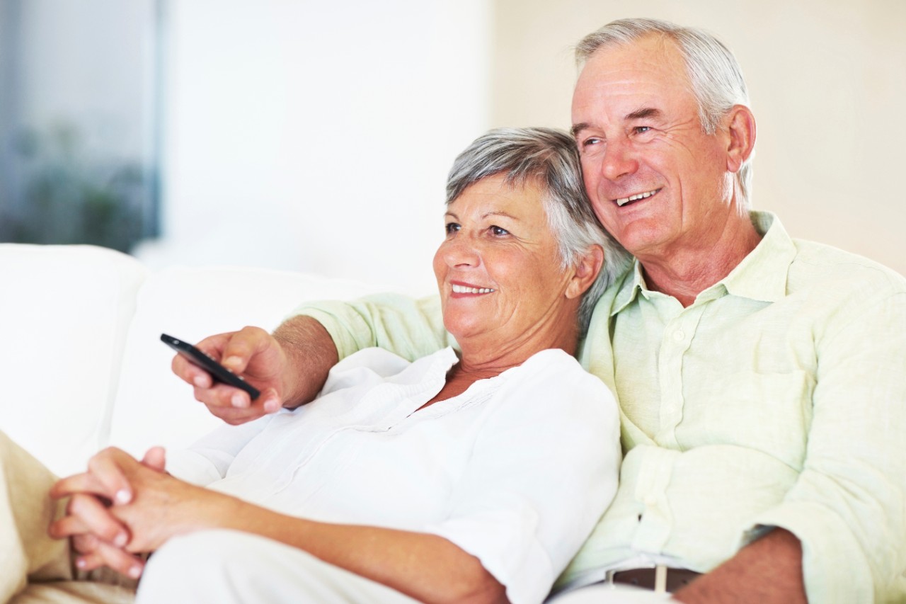 Relaxed couple watching television